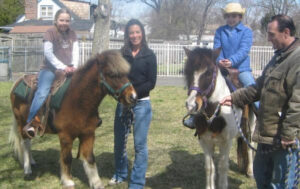 Pony rides and petting zoo animals at a kids party in Orange County