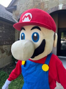 Mario adult mascot costume rental with nationwide shipping for children's birthday parties.