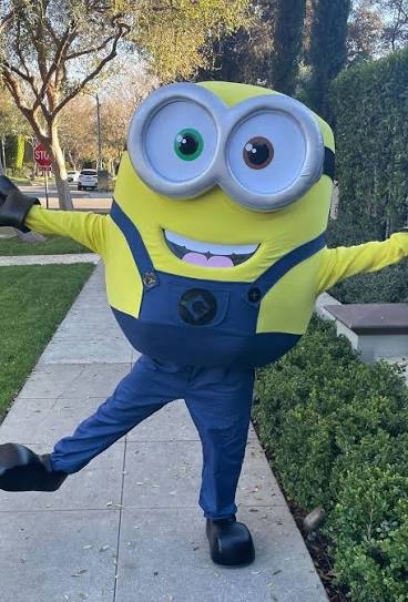 Despicable Me Minions birthday party costume character entertainer with children taking photos and celebrating